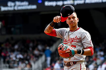 Jul 9, 2022; Cumberland, Georgia, USA; Washington Nationals left fielder Ehire Adrianza (5) readjusts his hat during a game against the Atlanta Braves at Truist Park. Mandatory Credit: Larry Robinson-USA TODAY Sports