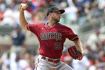 Jul 31, 2022; Atlanta, Georgia, USA; Arizona Diamondbacks starting pitcher Merrill Kelly (29) throws against the Atlanta Braves in the second inning at Truist Park. Mandatory Credit: Brett Davis-USA TODAY Sports