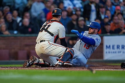 Aug 3, 2022; San Francisco, California, USA;  Los Angeles Dodgers third baseman Max Muncy (13) slides in safely against San Francisco Giants catcher Joey Bart (21) during the fourth inning at Oracle Park. Mandatory Credit: Neville E. Guard-USA TODAY Sports