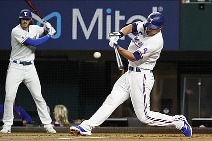 Aug 4, 2022; Arlington, Texas, USA; Texas Rangers shortstop Corey Seager (5) singles during the fifth inning against the Chicago White Sox at Globe Life Field. Mandatory Credit: Raymond Carlin III-USA TODAY Sports