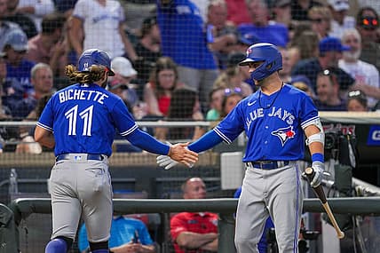 Aug 4, 2022; Minneapolis, Minnesota, USA; Toronto Blue Jays center fielder Whit Merrifield (1) congratulates shortstop Bo Bichette (11) after scoring against the Minnesota Twins in the sixth inning at Target Field. Mandatory Credit: Brad Rempel-USA TODAY Sports