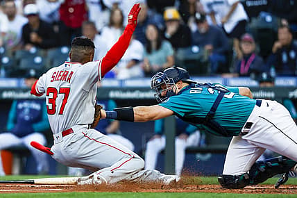 Aug 5, 2022; Seattle, Washington, USA; Seattle Mariners catcher Cal Raleigh (29) tags out Los Angeles Angels center fielder Magneuris Sierra (37) on an attempt to score on an inside-the-park homerun during the second inning at T-Mobile Park. Mandatory Credit: Joe Nicholson-USA TODAY Sports