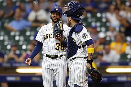 Aug 5, 2022; Milwaukee, Wisconsin, USA;  Milwaukee Brewers pitcher Devin Williams (38) talks with catcher Victor Caratini (7) during the ninth inning against the Cincinnati Reds at American Family Field. Mandatory Credit: Jeff Hanisch-USA TODAY Sports