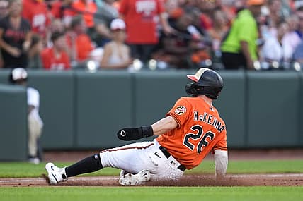 Aug 6, 2022; Baltimore, Maryland, USA; Baltimore Orioles left fielder Ryan McKenna (26) slides into third base after a pickoff error by Pittsburgh Pirates relief pitcher Eric Stout (not pictured) in the fifth inning at Oriole Park at Camden Yards. Mandatory Credit: Brent Skeen-USA TODAY Sports