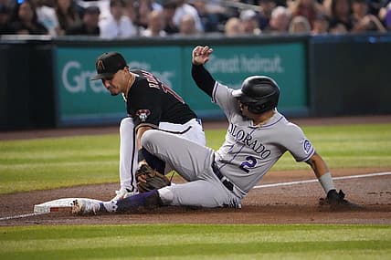 Aug 6, 2022; Phoenix, Arizona, USA; Colorado Rockies center fielder Yonathan Daza (2) beats the tag of Arizona Diamondbacks third baseman Josh Rojas (10) at third base during the third inning at Chase Field. Mandatory Credit: Joe Camporeale-USA TODAY Sports