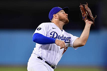 Aug 6, 2022; Los Angeles, California, USA; Los Angeles Dodgers third baseman Max Muncy (13) catches the fly ball of San Diego Padres first baseman Josh Bell (24) during the eighth inning at Dodger Stadium. Mandatory Credit: Gary A. Vasquez-USA TODAY Sports