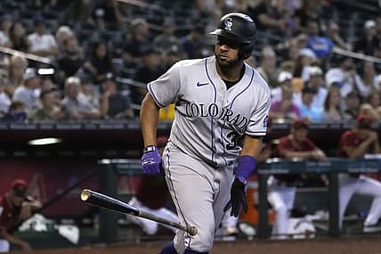 Aug 7, 2022; Phoenix, Arizona, USA; Colorado Rockies catcher Elias Diaz (35) tosses his bat after drawing a walk against the Arizona Diamondbacks in the sixth inning at Chase Field. Mandatory Credit: Rick Scuteri-USA TODAY Sports