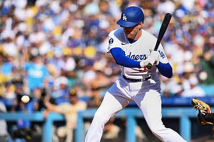 Aug 7, 2022; Los Angeles, California, USA; Los Angeles Dodgers first baseman Freddie Freeman (5) hits an RBI single against the San Diego Padres during third inning at Dodger Stadium. Mandatory Credit: Jonathan Hui-USA TODAY Sports