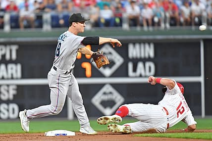 Aug 9, 2022; Philadelphia, Pennsylvania, USA; Miami Marlins second baseman Joey Wendle (18) gets force out on Philadelphia Phillies left fielder Kyle Schwarber (12) to and throes to first base to complete double play during the first inning at Citizens Bank Park. Mandatory Credit: Eric Hartline-USA TODAY Sports
