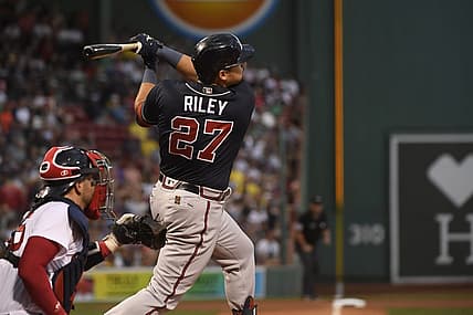 Aug 9, 2022; Boston, Massachusetts, USA;  Atlanta Braves third baseman Austin Riley (27) hits an RBI triple during the first inning against the Boston Red Sox at Fenway Park. Mandatory Credit: Bob DeChiara-USA TODAY Sports