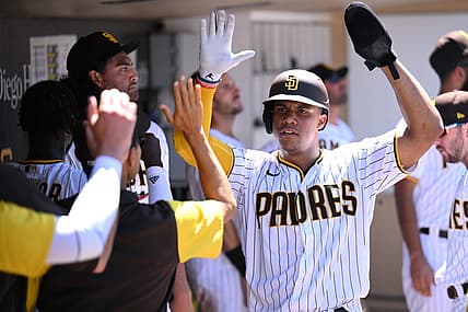 Aug 10, 2022; San Diego, California, USA; San Diego Padres right fielder Juan Soto (right) is congratulated in the dugout after scoring a run on a single hit by designated hitter Brandon Drury (17) during the third inning against the San Francisco Giants at Petco Park. Mandatory Credit: Orlando Ramirez-USA TODAY Sports