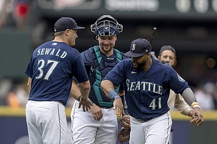 Aug 10, 2022; Seattle, Washington, USA; Seattle Mariners relief pitcher Paul Sewald (37), catcher Cal Raleigh (29) and designated hitter Carlos Santana (41) celebrate after a game against the New York Yankees at T-Mobile Park. Mandatory Credit: Stephen Brashear-USA TODAY Sports