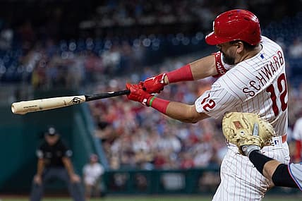 Aug 10, 2022; Philadelphia, Pennsylvania, USA; Philadelphia Phillies left fielder Kyle Schwarber (12) hits an RBI single during the eighth inning against the Miami Marlins at Citizens Bank Park. Mandatory Credit: Bill Streicher-USA TODAY Sports