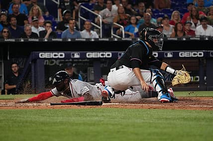 Aug 12, 2022; Miami, Florida, USA; Atlanta Braves center fielder Michael Harris II (23) scores a run behind Miami Marlins catcher Jacob Stallings (58) on the sac fly of shortstop Dansby Swanson (not pictured) in the sixth inning at loanDepot park. Mandatory Credit: Jasen Vinlove-USA TODAY Sports