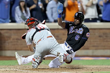 Aug 12, 2022; New York City, New York, USA; Philadelphia Phillies catcher J.T. Realmuto (10) tags out New York Mets right fielder Starling Marte (6) trying to score on a fly ball out by pinch hitter Daniel Vogelbach (not pictured) during the ninth inning at Citi Field. Mandatory Credit: Brad Penner-USA TODAY Sports