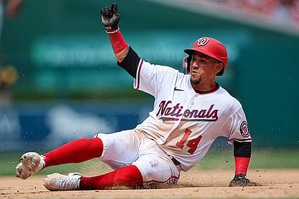 Aug 14, 2022; Washington, District of Columbia, USA; Washington Nationals shortstop Ildemaro Vargas (14) slides into third base and is returned during the eighth inning of the game against the San Diego Padres at Nationals Park. Mandatory Credit: Scott Taetsch-USA TODAY Sports