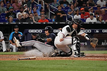 Aug 14, 2022; Miami, Florida, USA; Atlanta Braves second baseman Vaughn Grissom (18) scores a run behind Miami Marlins catcher Nick Fortes (54) on the single of catcher William Contreras (not pictured) in the ninth inning at loanDepot park. Mandatory Credit: Jasen Vinlove-USA TODAY Sports