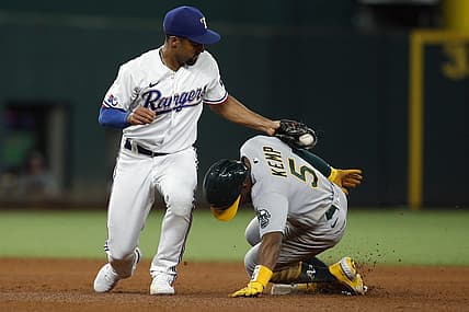 Aug 15, 2022; Arlington, Texas, USA; Oakland Athletics left fielder Tony Kemp (5) steals second base in the fifth inning as Texas Rangers second baseman Marcus Semien (2) applies the tag at Globe Life Field. Mandatory Credit: Tim Heitman-USA TODAY Sports