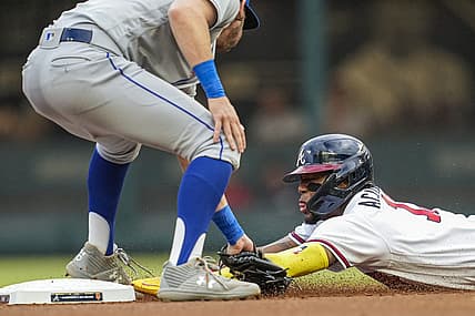 Aug 16, 2022; Cumberland, Georgia, USA; Atlanta Braves right fielder Ronald Acuna Jr. (13) is tagged out by New York Mets second baseman Jeff McNeil (1) while trying to steal during the first inning at Truist Park. Mandatory Credit: Dale Zanine-USA TODAY Sports