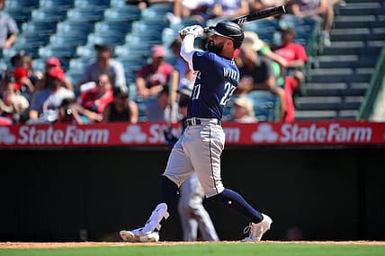Aug 17, 2022; Anaheim, California, USA; Seattle Mariners designated hitter Jesse Winker (27) hits a two run home run against the Los Angeles Angels during the sixth inning at Angel Stadium. Mandatory Credit: Gary A. Vasquez-USA TODAY Sports