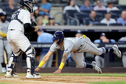 Aug 17, 2022; Bronx, New York, USA; Tampa Bay Rays center fielder Jose Siri (22) scores a run against New York Yankees catcher Jose Trevino (39) on a double by Rays third baseman Yandy Diaz (not pictured) during the third inning at Yankee Stadium. Mandatory Credit: Brad Penner-USA TODAY Sports