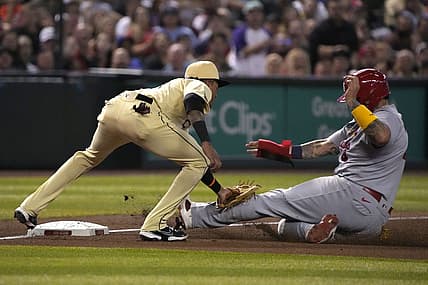 Aug 19, 2022; Phoenix, Arizona, USA; St. Louis Cardinals catcher Yadier Molina (4) gets tagged out by Arizona Diamondbacks third baseman Josh Rojas (10) in the fourth inning at Chase Field. Mandatory Credit: Rick Scuteri-USA TODAY Sports