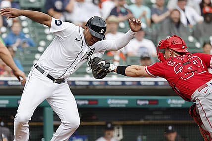 Aug 20, 2022; Detroit, Michigan, USA;  Detroit Tigers second baseman Jonathan Schoop (7) avoids the first tag by Los Angeles Angels catcher Max Stassi (33) in the third inning at Comerica Park. Mandatory Credit: Rick Osentoski-USA TODAY Sports