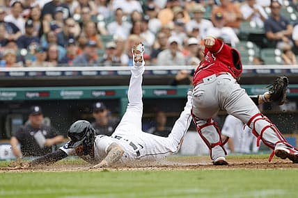 Aug 20, 2022; Detroit, Michigan, USA;  Detroit Tigers designated hitter Eric Haase (13) dives in safe at home ahead of the tag by Los Angeles Angels catcher Max Stassi (33) in the third inning at Comerica Park. Mandatory Credit: Rick Osentoski-USA TODAY Sports