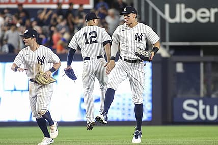 Aug 22, 2022; Bronx, New York, USA;  New York Yankees shortstop Isiah Kiner-Falefa (12) and center fielder Aaron Judge (99) celebrate after defeating the New York Mets 4-2 at Yankee Stadium. Mandatory Credit: Wendell Cruz-USA TODAY Sports
