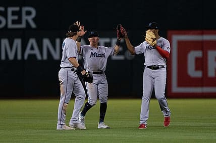 Aug 22, 2022; Oakland, California, USA; (l to r) Miami Marlins left fielder JJ Bleday (67) and center fielder Peyton Burdick (86) and right fielder Jerar Encarnacion (64) celebrate after defeating the Oakland Athletics at RingCentral Coliseum. Mandatory Credit: Stan Szeto-USA TODAY Sports