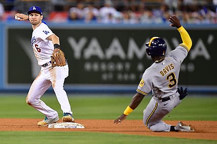 Aug 23, 2022; Los Angeles, California, USA; Milwaukee Brewers center fielder Jonathan Davis (3) is out at second as Los Angeles Dodgers shortstop Trea Turner (6) throws to first for the out against left fielder Christian Yelich (22) during the fifth inning at Dodger Stadium. Mandatory Credit: Gary A. Vasquez-USA TODAY Sports