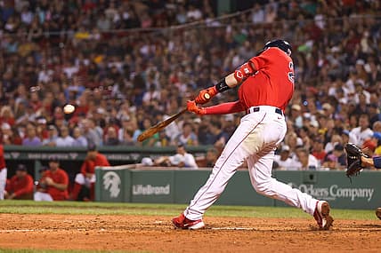 Aug 26, 2022; Boston, Massachusetts, USA; Boston Red Sox catcher Kevin Plawecki (25) hits an RBI during the fifth inning against the Tampa Bay Rays at Fenway Park. Mandatory Credit: Paul Rutherford-USA TODAY Sports