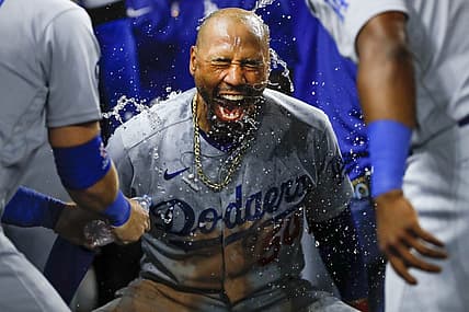 Aug 26, 2022; Miami, Florida, USA; Los Angeles Dodgers right fielder Mookie Betts (50) celebrates as third baseman Justin Turner (10) and second baseman Hanser Alberto (17) pour water over his head after hitting a two-run home run during the seventh inning against the Miami Marlins at loanDepot Park. Mandatory Credit: Sam Navarro-USA TODAY Sports