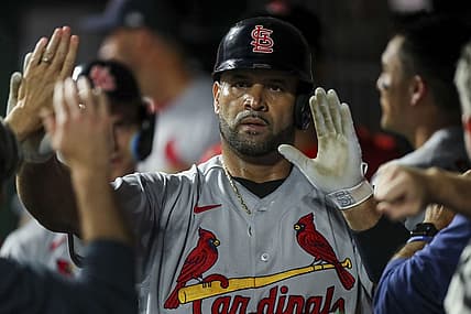 Aug 29, 2022; Cincinnati, Ohio, USA; St. Louis Cardinals first baseman Albert Pujols (5) high fives teammates after hitting a two-run home run against the Cincinnati Reds in the third inning at Great American Ball Park. Mandatory Credit: Katie Stratman-USA TODAY Sports