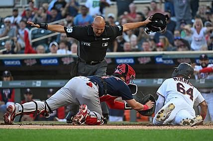 Aug 30, 2022; Minneapolis, Minnesota, USA; Minnesota Twins designated hitter Jose Miranda (64) scores a run ahead of the tag by Boston Red Sox catcher Reese McGuire (3) on a double hit by outfielder Nick Gordon (not pictured) during the first inning at Target Field. Mandatory Credit: Nick Wosika-USA TODAY Sports