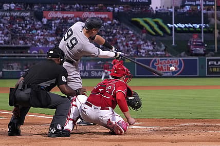 Aug 30, 2022; Anaheim, California, USA; New York Yankees center fielder Aaron Judge (99) bats in the third inning as Los Angeles Angels catcher Max Stassi (33) and home plate umpire Alan Porter watch at Angel Stadium. Mandatory Credit: Kirby Lee-USA TODAY Sports