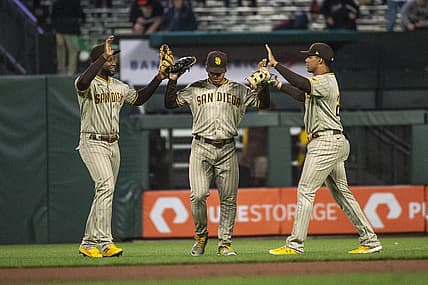 Aug 30, 2022; San Francisco, California, USA;  San Diego Padres left fielder Jurickson Profar (10) and center fielder Trent Grisham (2) and right fielder Juan Soto (22) celebrate after defeating the San Francisco Giants at Oracle Park. Mandatory Credit: Ed Szczepanski-USA TODAY Sports
