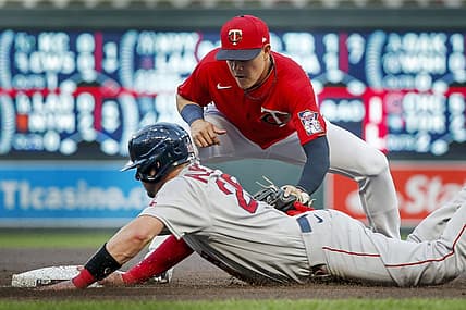 Aug 31, 2022; Minneapolis, Minnesota, USA; Boston Red Sox catcher Kevin Plawecki (25) returns safely to third base before Minnesota Twins third baseman Gio Urshela (15) can apply the tag on a fielder's choice in the third inning at Target Field. Mandatory Credit: Bruce Kluckhohn-USA TODAY Sports