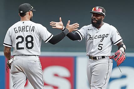 Jul 17, 2022; Minneapolis, Minnesota, USA; Chicago White Sox shortstop Leury Garcia (28) celebrates with second baseman Josh Harrison (5) the win over the Minnesota Twins at Target Field. Mandatory Credit: Bruce Kluckhohn-USA TODAY Sports