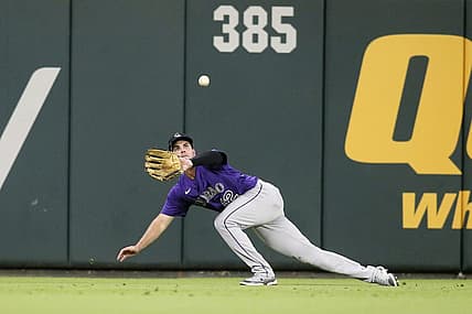 Aug 30, 2022; Atlanta, Georgia, USA; Colorado Rockies left fielder Sean Bouchard (12) makes a diving catch against the Atlanta Braves in the fourth inning at Truist Park. Mandatory Credit: Brett Davis-USA TODAY Sports