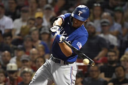 Sep 1, 2022; Boston, Massachusetts, USA;  Texas Rangers shortstop Corey Seager (5) hits an RBI single during the third inning against the Boston Red Sox at Fenway Park. Mandatory Credit: Bob DeChiara-USA TODAY Sports