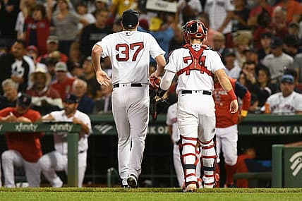 Sep 2, 2022; Boston, Massachusetts, USA; Boston Red Sox starting pitcher Nick Pivetta (37) limps off of the field with catcher Connor Wong (74) after the third inning of a game against the Texas Rangers at Fenway Park. Mandatory Credit: Brian Fluharty-USA TODAY Sports