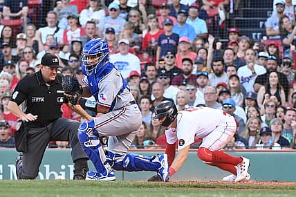 Sep 3, 2022; Boston, Massachusetts, USA; Boston Red Sox center fielder Enrique Hernandez (5) beats Texas Rangers catcher Meibrys Viloria (20) at the plate to score at Fenway Park. Mandatory Credit: Eric Canha-USA TODAY Sports