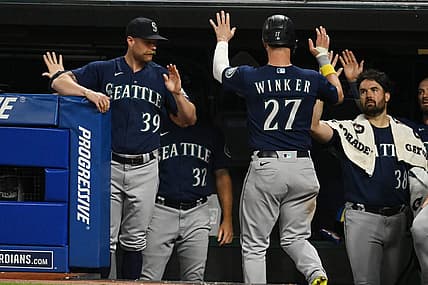 Sep 3, 2022; Cleveland, Ohio, USA; Seattle Mariners left fielder Jesse Winker (27) celebrates with major league field coordinator Carson Vitale (39) and starting pitcher Robbie Ray (38) after scoring during the fifth inning against the Cleveland Guardians at Progressive Field. Mandatory Credit: Ken Blaze-USA TODAY Sports