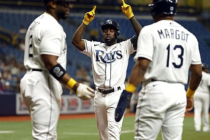 Sep 6, 2022; St. Petersburg, Florida, USA;Tampa Bay Rays left fielder Randy Arozarena (56) is congratulated by  third baseman Yandy Diaz (2) and right fielder Manuel Margot (13) after he hit a three-run home run against the Boston Red Sox during the first inning at Tropicana Field. Mandatory Credit: Kim Klement-USA TODAY Sports