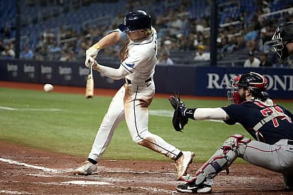 Sep 7, 2022; St. Petersburg, Florida, USA; Tampa Bay Rays shortstop Taylor Walls (0) hits a single and drives catcher Francisco Mejia (21) in the fifth inning at Tropicana Field. Mandatory Credit: Dave Nelson-USA TODAY Sports