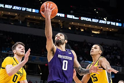 Mar 10, 2022; Indianapolis, IN, USA; Northwestern Wildcats guard Boo Buie (0) shoots the ball while Iowa Hawkeyes forward Filip Rebraca (0) defends in the second half at Gainbridge Fieldhouse. Mandatory Credit: Trevor Ruszkowski-USA TODAY Sports