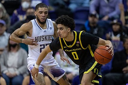 Mar 3, 2022; Seattle, Washington, USA; Oregon Ducks Will Richardson (0) dribbles the ball against Washington Huskies guard Terrell Brown Jr. (23) at Alaska Airlines Arena at Hec Edmundson Pavilion. Mandatory Credit: Stephen Brashear-USA TODAY Sports
