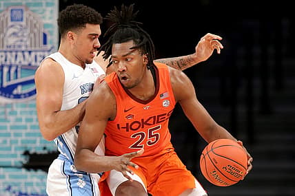 Mar 11, 2022; Brooklyn, NY, USA; Virginia Tech Hokies forward Justyn Mutts (25) controls the ball against North Carolina Tar Heels forward Justin McKoy (22) during the first half of the ACC Tournament semifinal game at Barclays Center. Mandatory Credit: Brad Penner-USA TODAY Sports