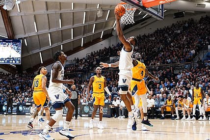 Nov 7, 2022; Villanova, Pennsylvania, USA; Villanova Wildcats forward Eric Dixon (43) shoots a reverse layup against La Salle Explorers forward Hassan Drame (4)  during the first half at William B. Finneran Pavilion. Mandatory Credit: Gregory Fisher-USA TODAY Sports